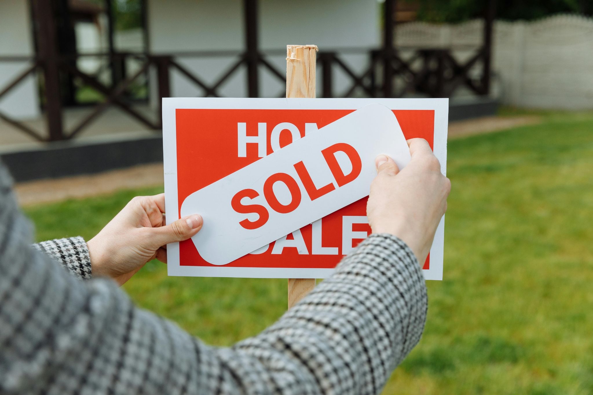 sold sign covering a for sale sign 