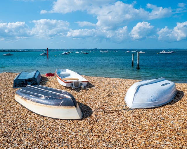 Portsmouth beach with boats turned upside down on the shore